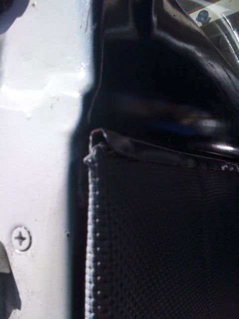 1964 Ford Ranchero - Detail of a car's interior door panel, showing the textured fabric and painted metal frame.
