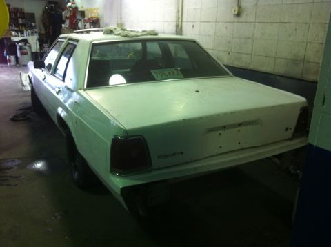 1991 Ford LTD Crown Victoria - This 1991 Ford Crown Victoria LTD is shown in a garage, possibly undergoing restoration or preparation for painting.