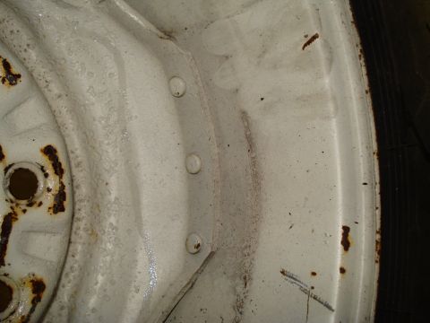 1967 Ford F-250 - Close-up view of a white wheel rim, showing signs of wear and rust.