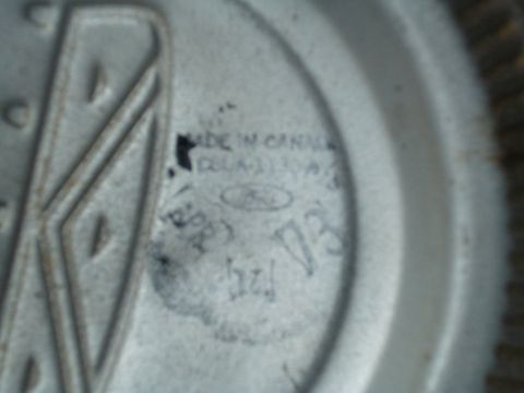 1967 Ford F-250 - A close-up view of a Ford emblem, showing manufacturing details and part identification.