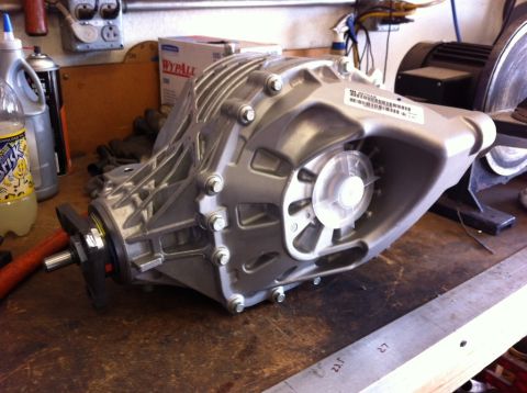 2010 Dodge Challenger - A close-up view of a differential assembly resting on a wooden surface in a workshop setting.