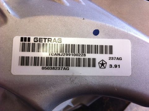 2010 Dodge Challenger - A Getrag transmission part is shown with a label containing barcodes and manufacturer information.