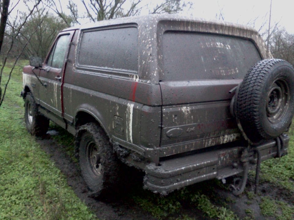 Mud-covered 1989 Ford Bronco rear view with spare tire