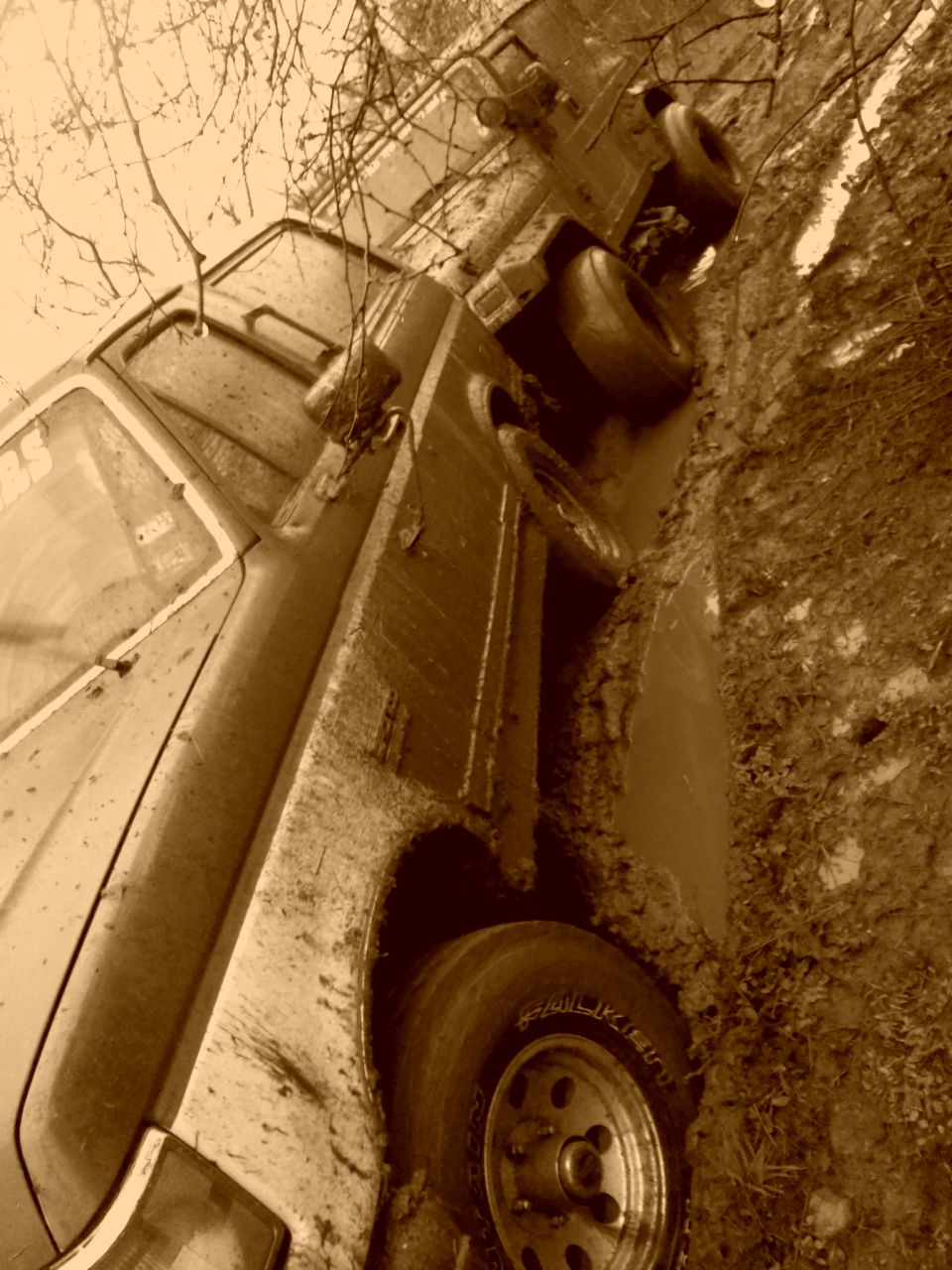 1989 Ford Bronco stuck in mud, side view