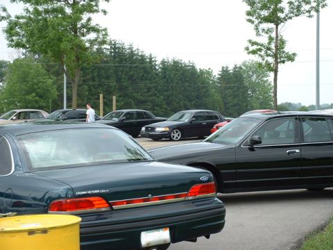 2000 Ford Crown Victoria - A group of Ford Crown Victoria sedans are parked outdoors on a cloudy day.