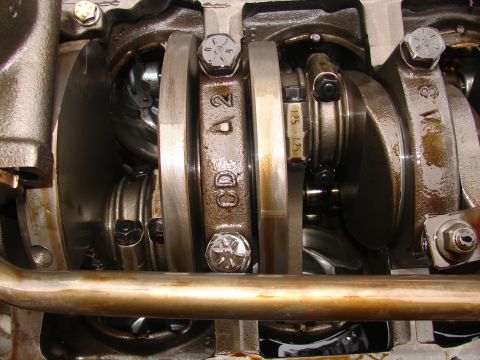 1973 Ford Ranchero - Close-up view of an engine's crankshaft and connecting rods, revealing part numbers and measurements.