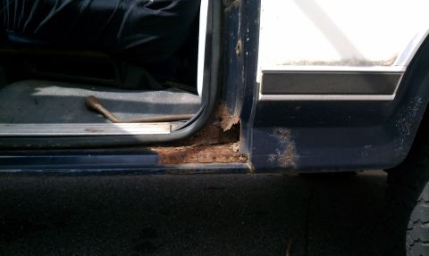 1984 Ford Bronco - The door sill of this vehicle has extensive rust, indicating potential structural issues.
