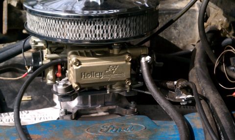 1984 Ford Bronco - Close-up of a Holley carburetor and air cleaner assembly, with a Ford logo visible.