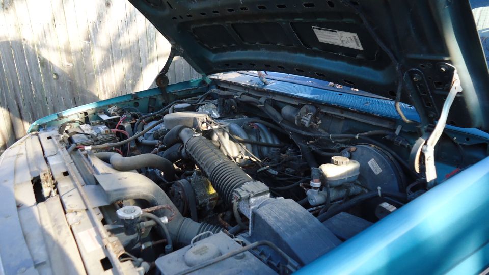 Teal 1996 Ford Bronco engine bay with hood open