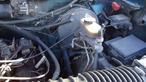 1996 Ford Bronco - Close-up of a vehicle's engine bay, focusing on the brake system components.
