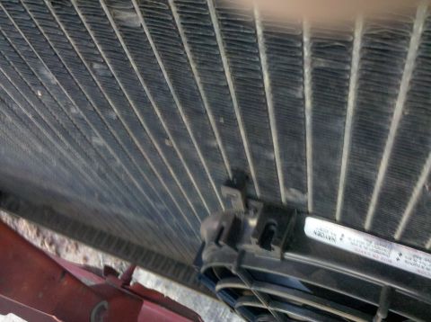 1979 Ford Bronco - Close-up of a radiator and electric fan assembly, with visible text on a label.