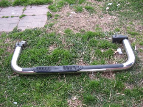 1994 Ford Bronco - This is a single nerf bar, likely an aftermarket accessory, shown on a grassy surface.