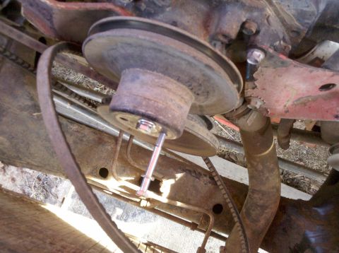 1979 Ford Bronco - This image shows a close-up view of worn engine pulleys and belts, with a bolt inserted through one of the pulleys.