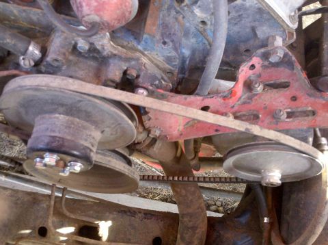1979 Ford Bronco - Close-up view of engine pulleys and belts, showing wear and rust on components.