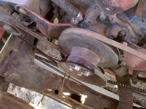 1979 Ford Bronco - Close-up view of an engine's pulley and belt system, showing mechanical components and hoses.