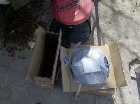 1979 Ford Bronco - A car part is shown in its packaging on a concrete surface.