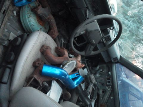 1988 Toyota Hilux - The interior of a vehicle is filled with engine parts, obscuring the view of the dashboard and seats.