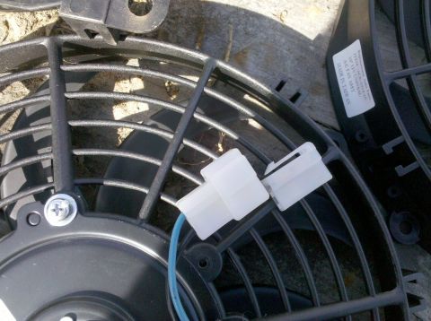 1979 Ford Bronco - Close-up of an electric fan, likely for automotive use, with visible wiring and connectors.