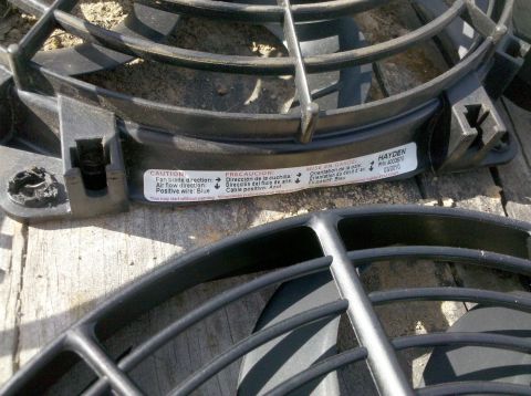 1979 Ford Bronco - Close-up of two electric cooling fans, one with a Hayden part number and date.