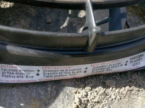 1979 Ford Bronco - This image shows a close-up of an electric fan, not a 1979 Ford Bronco, with multilingual warning labels.