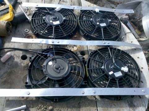 1979 Ford Bronco - Four electric cooling fans are shown mounted on metal brackets, likely for an automotive application.