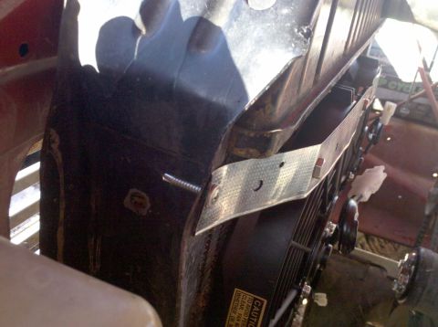 1979 Ford Bronco - Close-up view of an electric fan installation, showing the fan mounted to the radiator support with a custom metal bracket.