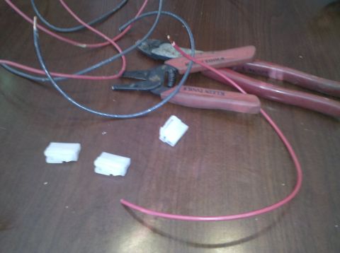 1979 Ford Bronco - Electrical wiring components and tools are laid out on a table, ready for installation.
