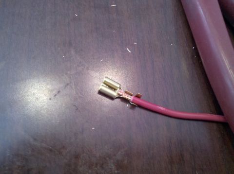 1979 Ford Bronco - Close-up of a wire with a brass connector, likely for an electrical installation.