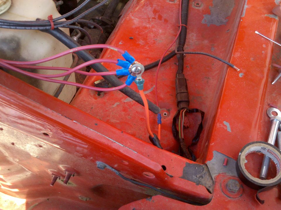 Engine bay wiring with blue connectors and red wires