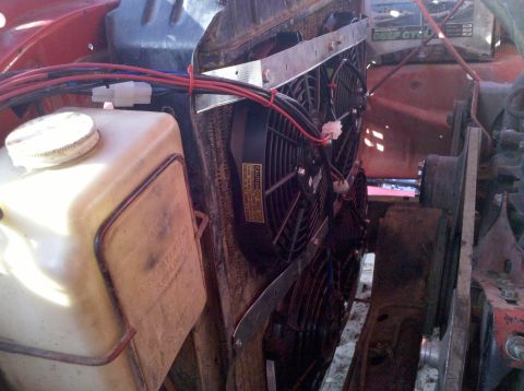 1979 Ford Bronco - Close-up view of an engine bay showing an aftermarket electric fan installation.