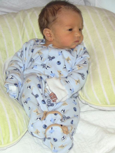 1978 Ford Bronco - A baby lies on a pillow, wearing blue pajamas with a pattern of toys and teddy bears.