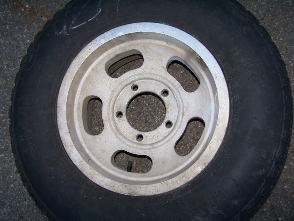 Close-up of a tire and a five-spoke aluminum rim