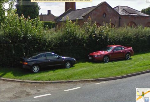 2003 Mercury Marauder - Two cars, a red Ford Mustang Cobra and a black Toyota Celica, are parked on a grassy area.