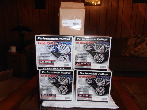 1990 Ford Bronco - March Performance Pulleys are displayed in their packaging, stacked for storage.