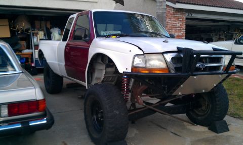 1992 Ford Ranger - This 1992 Ford Ranger features a custom front bumper and lifted suspension, with a two-tone maroon and white paint scheme.