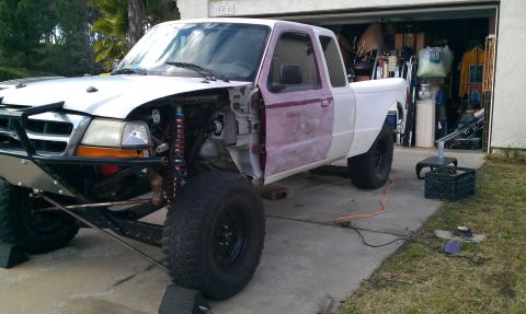 1992 Ford Ranger - A 1992 Ford Ranger is parked in a driveway, with its front end partially disassembled for modifications.