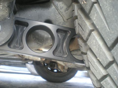 2004 Ford Crown Victoria - A close-up view of the undercarriage of a vehicle, focusing on a suspension component.