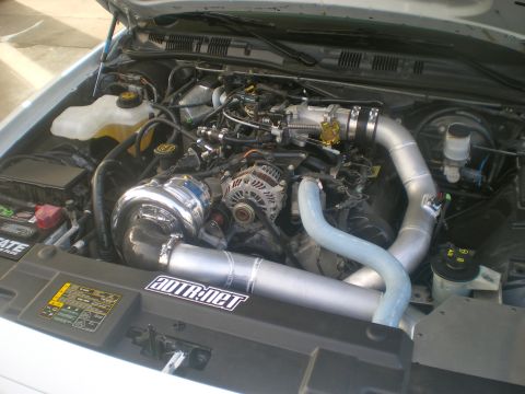 2004 Ford Crown Victoria - The engine bay features a prominent turbocharger and custom intake piping, with a visible sticker indicating a website.