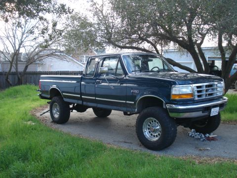 1994 Ford F-250 - This lifted 1994 Ford F-250 pickup truck is shown from the front three-quarter view.