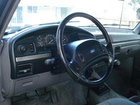1994 Ford F-250 - Interior view of a Ford truck, displaying the dashboard, steering wheel, and manual transmission shifter.