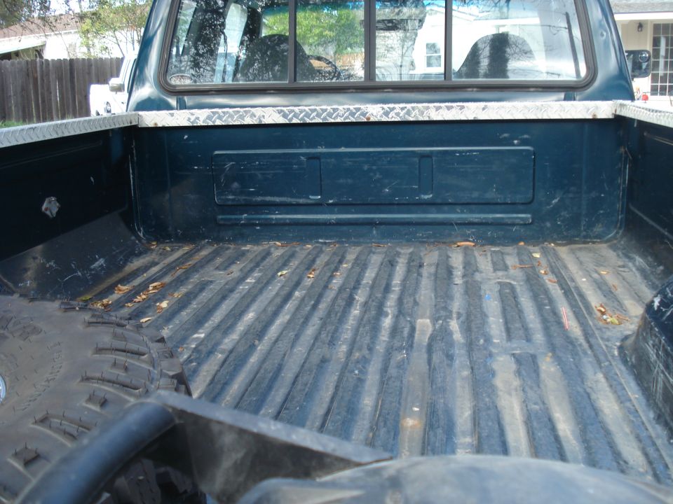 Dark blue 1994 Ford F-250 pickup truck bed with diamond plate trim