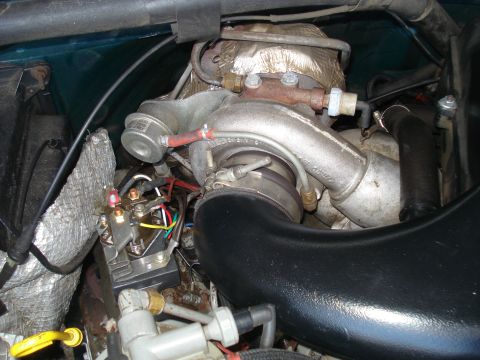 1994 Ford F-250 - Engine bay detail showing a turbocharger and associated plumbing and wiring.