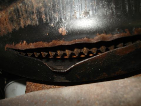 1994 Ford F-250 - A close-up view of a rusted metal component, possibly from a vehicle's drivetrain, with a visible Supermotors.net watermark.