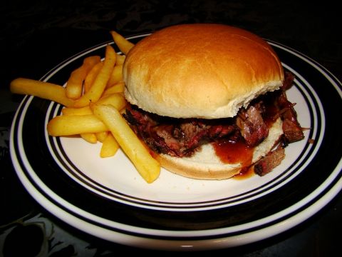 1989 Ford Bronco - A close-up of a barbecue brisket sandwich with a side of french fries.