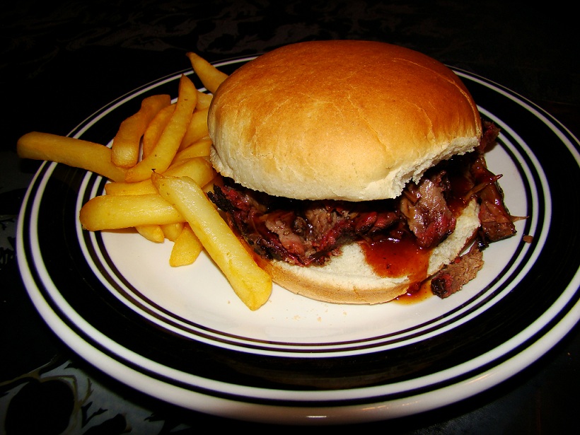 barbecue brisket sandwich and fries on a plate
