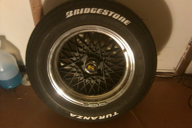 Bridgestone Turanza tire on a wire-spoke wheel with a black center cap