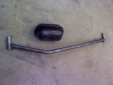 1996 Ford Bronco - A custom sway bar and a black rubber bushing are laid out on a concrete surface.