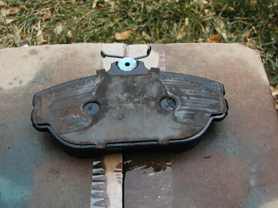 OEM shim clamped onto a Hawk pad.