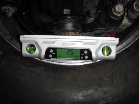 1995 Ford Bronco - A digital level is placed on a tire, indicating a measurement of 2.6 degrees.