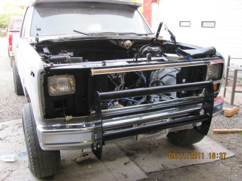1985 Ford F-150 - Front view of a 1985 Ford F-150 with its hood open, revealing the engine bay and a bull bar.